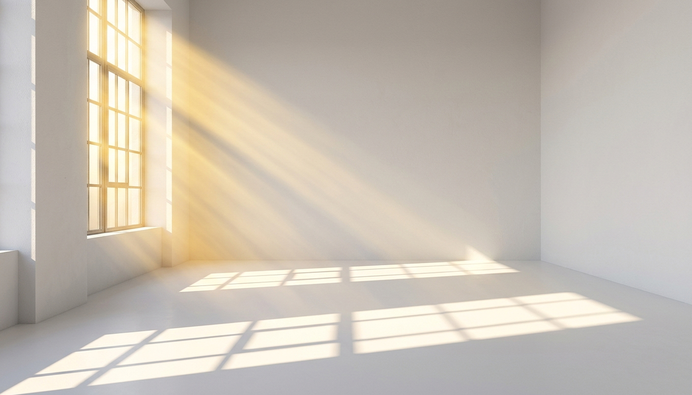 Dramatic natural light casting geometric shadows on the floor