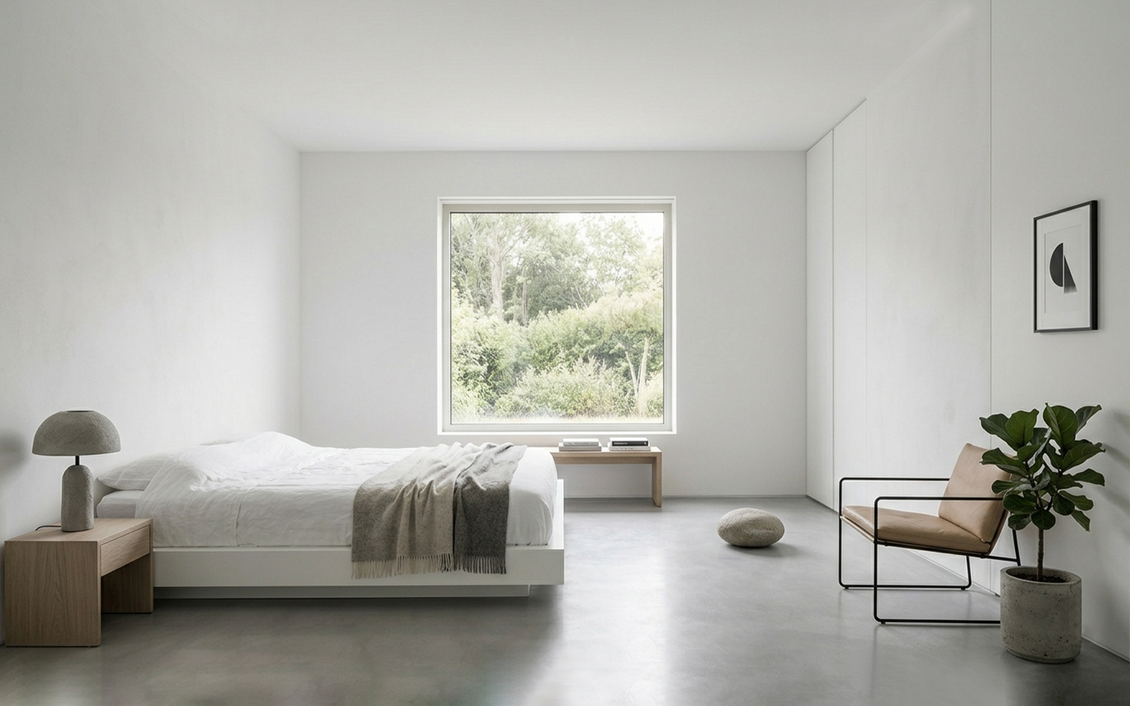 Minimalist interior with white walls, concrete floor, essential furniture and zero ornament